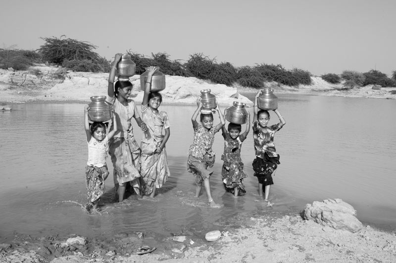 Children and Water - Fetching drinking water from an open pond in Kutch district, Gujarat